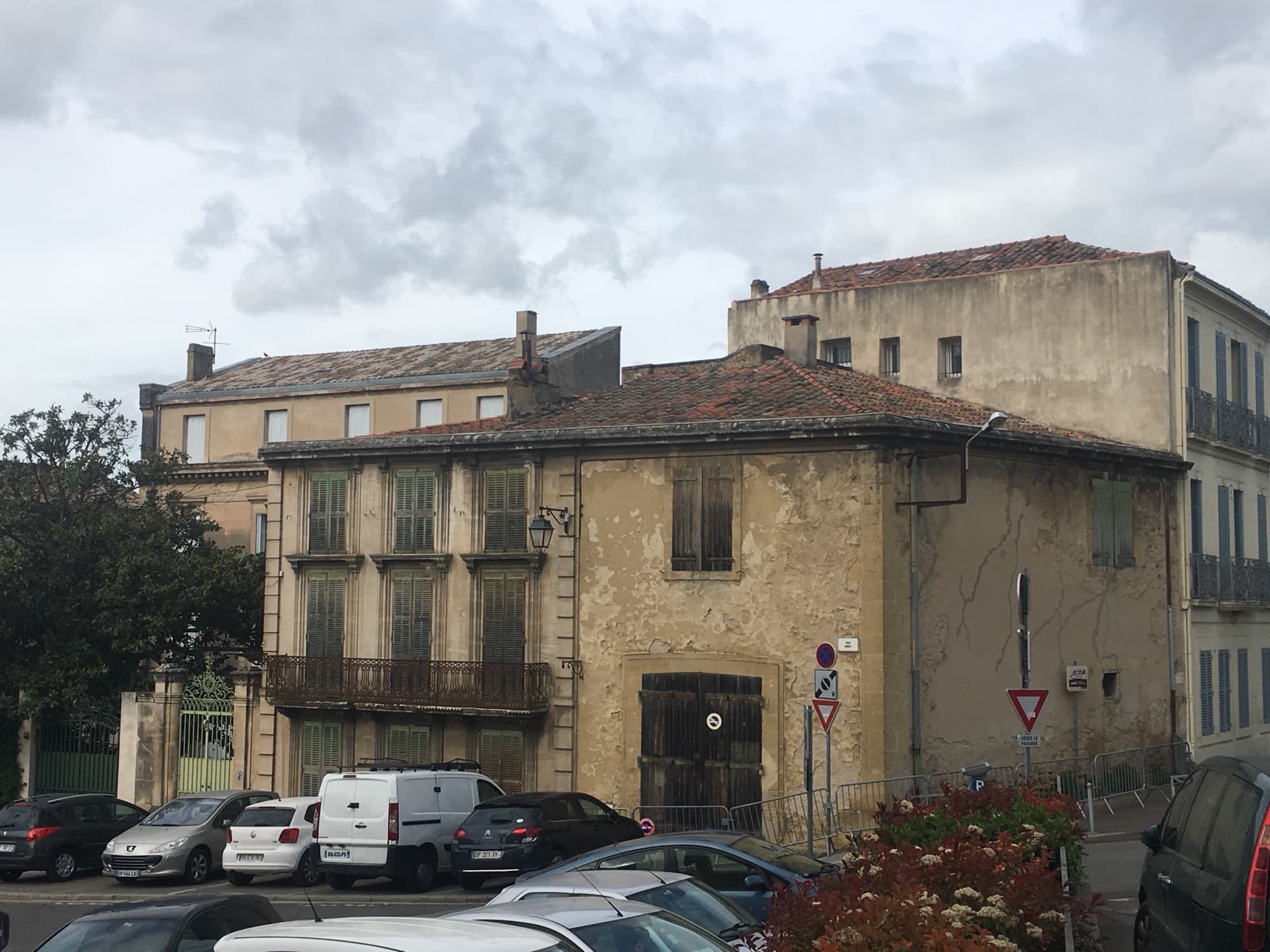 Façade avant travaux : pierre encrassée, volets délavés et balcon rouillé
